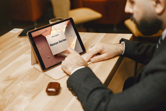 Person using a tablet displaying 'Nexus Series' SMM guide on a wooden table.