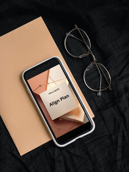 Phone displaying a 'Align Plan' on a notebook with glasses beside it